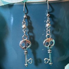 Antique Style Polished Silver Color Plated Skeleton Key with Heart Dangle Earrings | Gifts for Readers, Writers, and Fantasy Lovers  Great earrings for literary lovers and wordsmiths, and everyone!  Product Specs: Key Charm: Approx 25 x 3mm Dangle/Drop hook stainless steel (hypoallergenic)  Color of actual product may vary a bit due to different lighting, and slight variances will occur as each earring is handcrafted. Shipping: At moment, I have limited stock, so occasionally, a pair of earrings Fantasy Lovers, Heart Dangle Earrings, Skeleton Key, Polish Silver, Gifts For Readers, Limited Stock, Antique Style, Earring Gifts, Silver Color