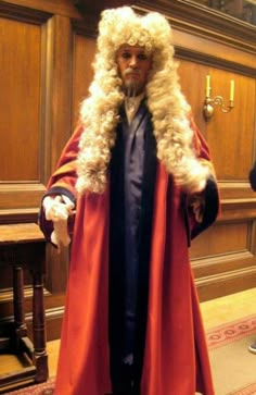 a man dressed up in a red cape and fur coat