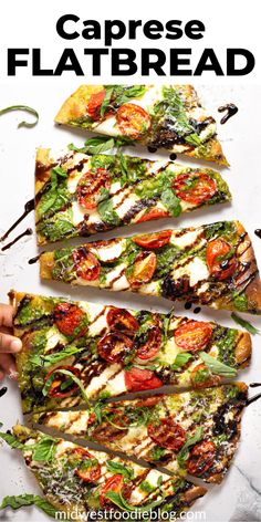 a pizza with tomatoes, mozzarella and spinach on it is cut into eight slices