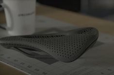 a pair of shoes sitting on top of a table next to a cup and ruler