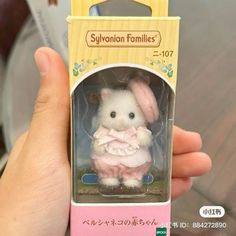 a small toy rabbit in a pink box