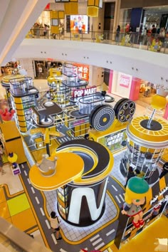 the inside of a shopping mall with lots of tables and chairs on top of it