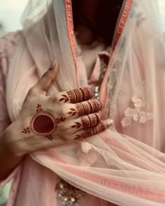 a woman with her hands painted in hendi