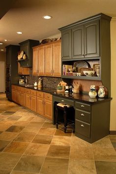 a kitchen filled with lots of wooden cabinets