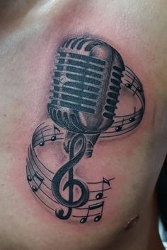 a microphone and musical notes tattoo on the chest