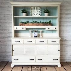 a white dresser with plants on top