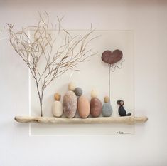 there is a shelf with rocks and a tree on it