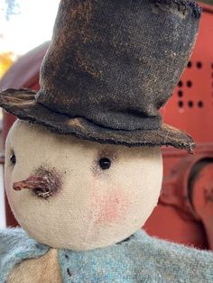 an old fashioned snowman with a hat and tie