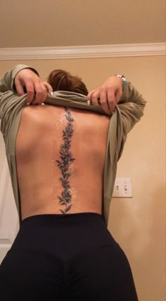 the back of a woman's body with flowers on it