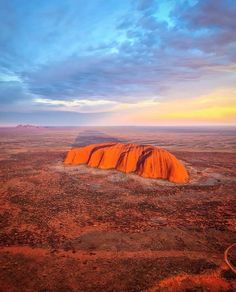 an orange rock in the middle of nowhere