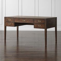 an antique desk with two drawers on the top and one drawer at the bottom, in front of a white wall