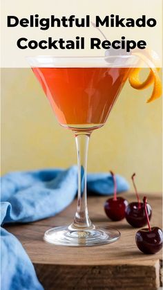 a cocktail in a martini glass garnished with an orange slice and cherries