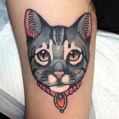 a black and white cat tattoo on the leg