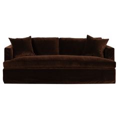 a brown couch sitting on top of a white floor