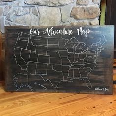 a wooden sign with the map of the united states on it that says our adventure map