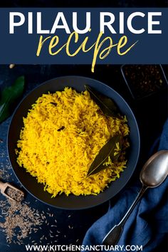 yellow rice in a black bowl with spoons and spices on the table next to it