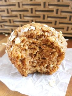 an oatmeal muffin sitting on top of a piece of wax paper