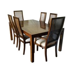 a dining table with six chairs and a bench on the other side, in front of a white background