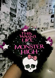 a woman's hand holding up a black and white stuffed animal with the words, this was like monster high on it