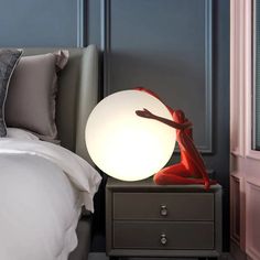 a bed room with a lamp and a night stand