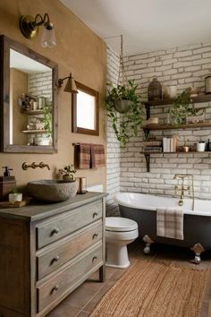 a bathroom with a tub, sink, toilet and mirror on the wall above it