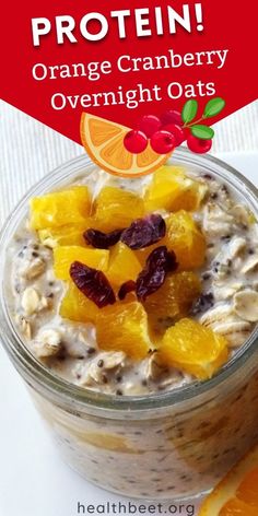 an orange cranberry overnight oatmeal in a glass bowl with fruit on top