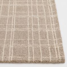 a beige rug with white squares on it