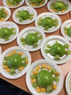 paper plates with green apples shaped like animals on them and faces made to look like turtles