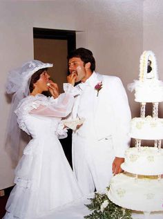 a bride and groom feeding each other cake