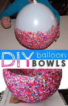 a child holding a balloon in front of a bowl filled with sprinkles