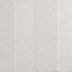 a white tile wall with wavy lines on it