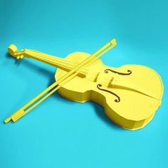 a yellow violin on a blue background with two sticks sticking out of the top of it