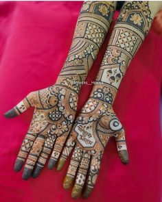 a woman's hands decorated with hennap