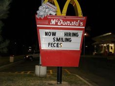 a mcdonald's restaurant sign with the words now hiring smiling faces written on it