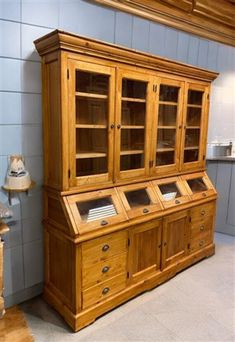 a wooden cabinet with glass doors in a room