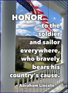 an american flag hanging from the side of a porch with text that reads, honor to the soldier and sailor everywhere, who bravely bears his country's cause