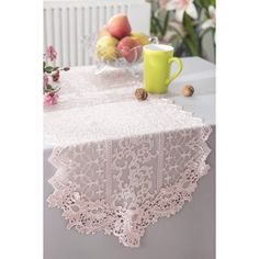 a table topped with a white lace covered table cloth