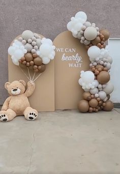 a teddy bear holding balloons in front of a sign that says we can be sorry wait