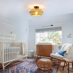 a baby's room with a crib, rocking chair, and dresser in it