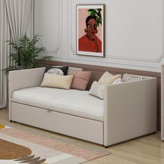 a living room with a white couch and a painting on the wall