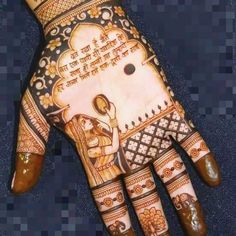 the hand is decorated with henna and designs on it's palm, which has an image of a woman holding a baby in her lap