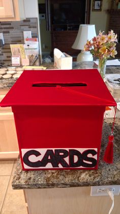 a red box with the word cards on it sitting on top of a kitchen counter