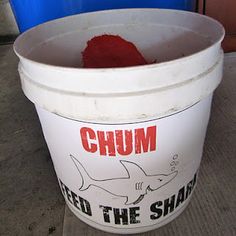 a bucket filled with red stuff sitting on top of a table