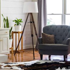 a living room with a chair, lamp and rug