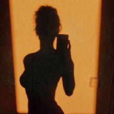 the shadow of a woman holding a camera