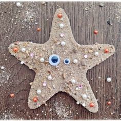 a starfish made out of sand with an eye on it's face and beads around its eyes