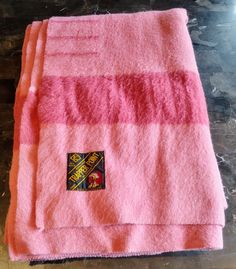 two pink towels sitting on top of a table