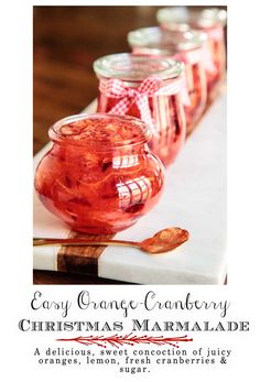 three jars filled with jelly sitting on top of a table