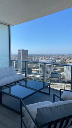 a balcony with furniture and a view of the city