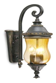 an old fashioned wall light with two lights on it's side and one light on the